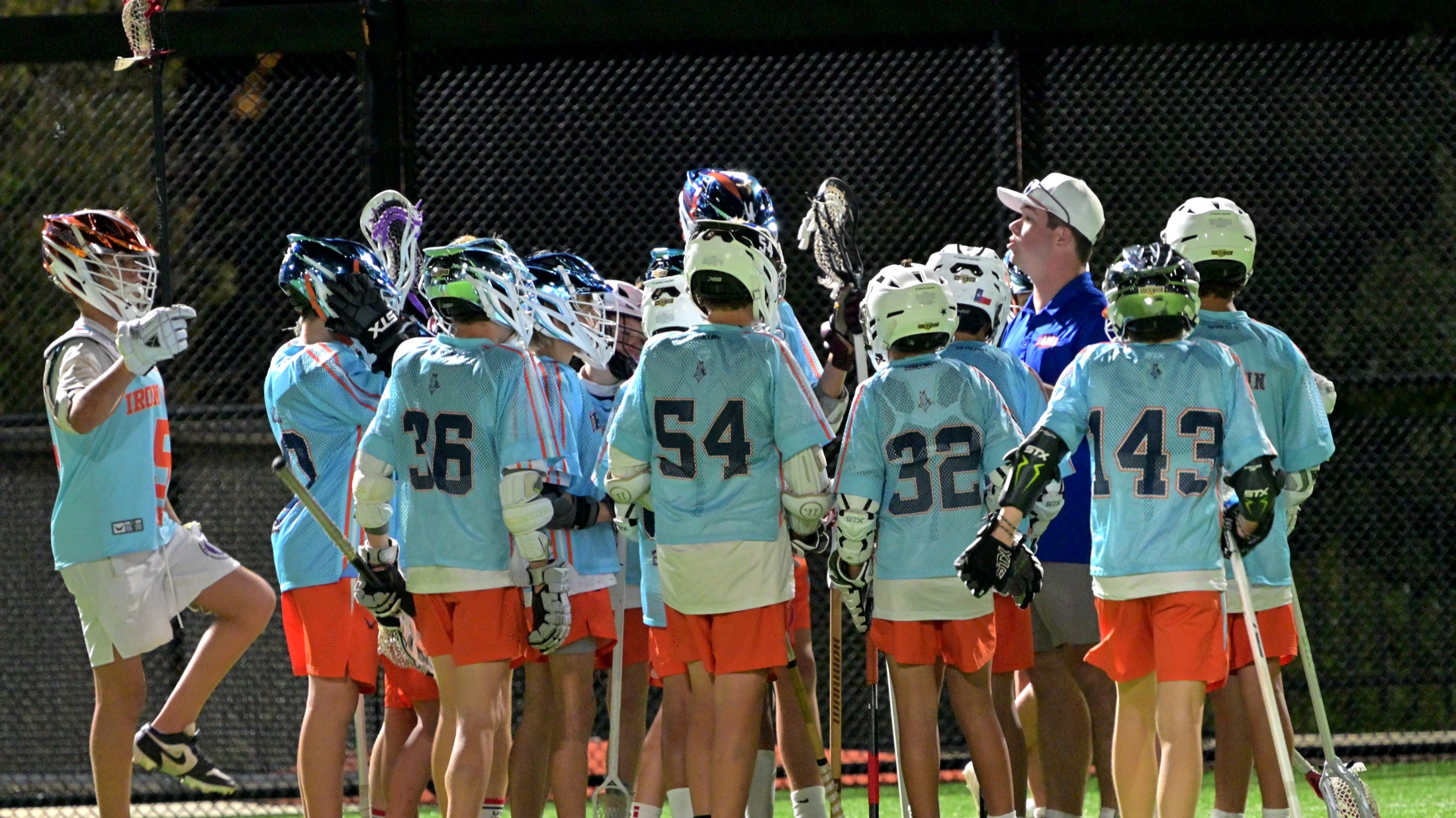 ADVNC ATX team gathered in a sideline huddle